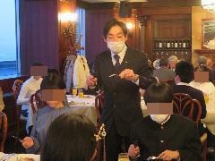 テーブルを回って説明する講師