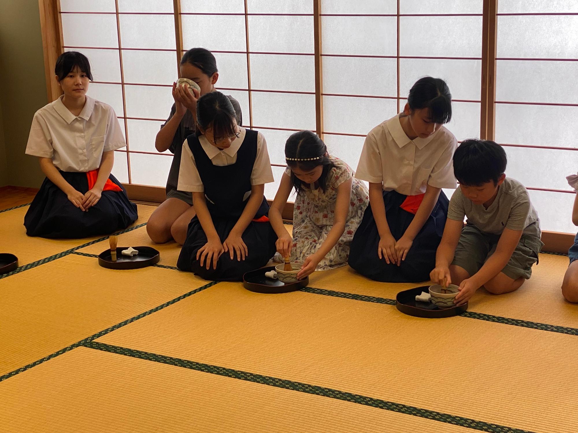 参加者に作法を教える茶道部の生徒さん