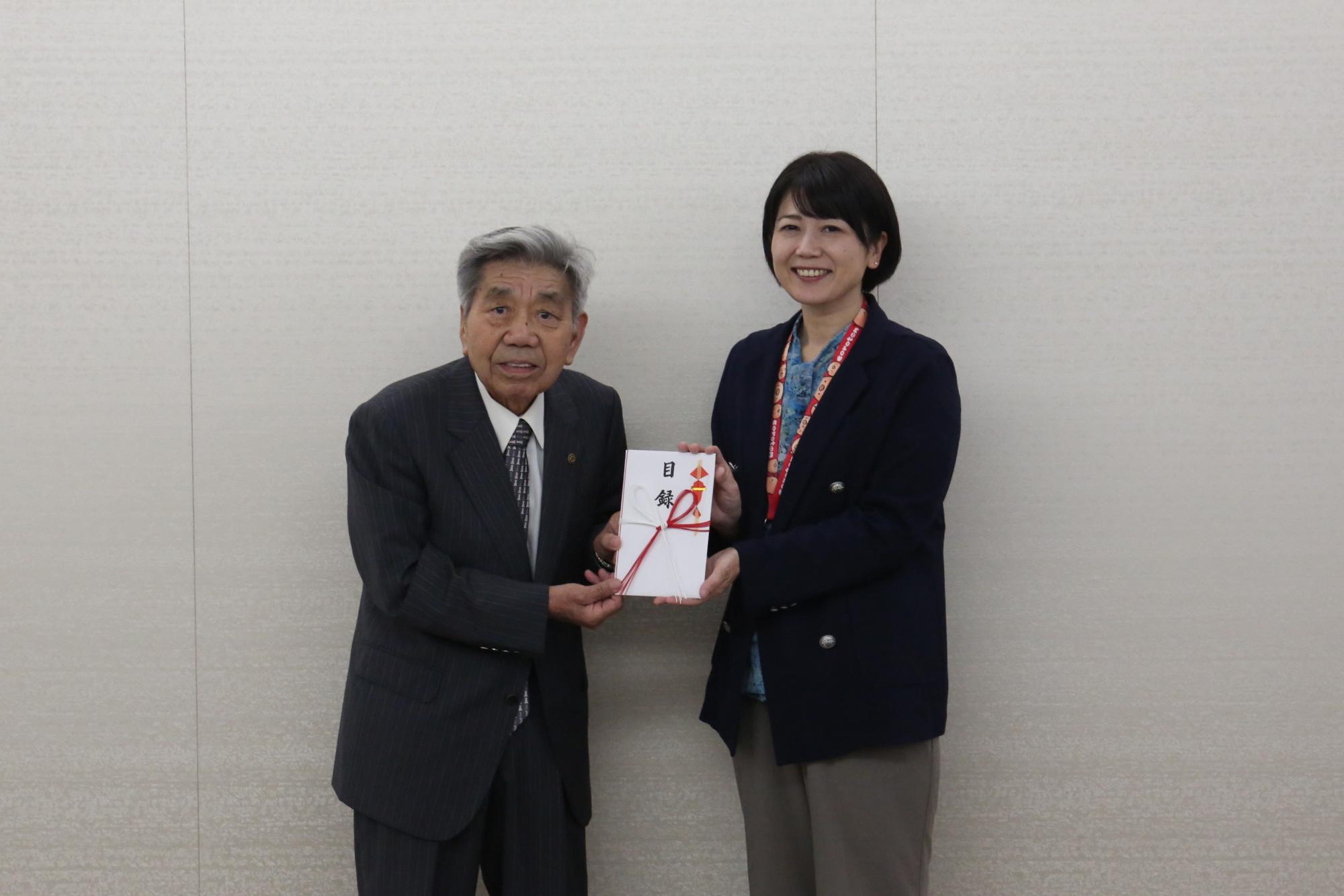 目録を手にする関係者と小川市長