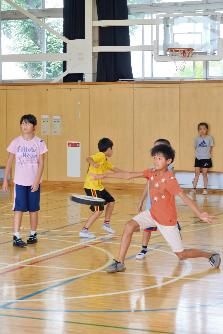 フライングディスクを投げる小学生