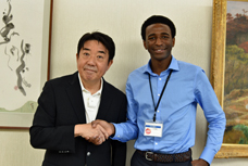 新しく就任した国際交流員と、市長が握手をしている写真です。